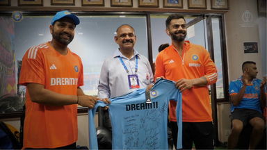 Team India present signed jersey to DDCA dressing room attendant Vinod Kumar